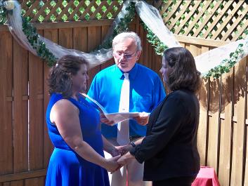 Ralph Fishburn, of Ralph's Regal Weddings, performing wedding for same-sex couple at Ralph's Regal Weddings, Spokane, Washington.