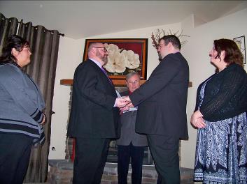 Ralph Fishburn, of Ralph's Regal Weddings, performing wedding for a same-sex couple in a private home in Spokane, Washington.